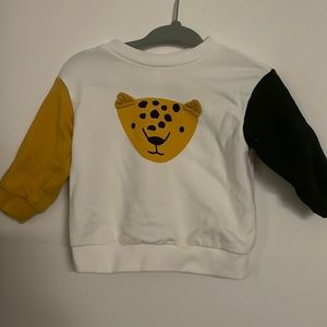 Long Sleeve sweater. Mustard and Dark Grey sleeve. Button up on the back.